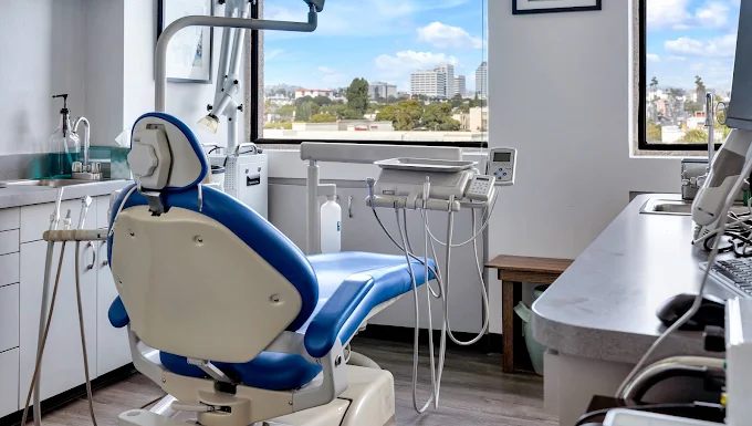 Dental chair and instrument tray beside the window